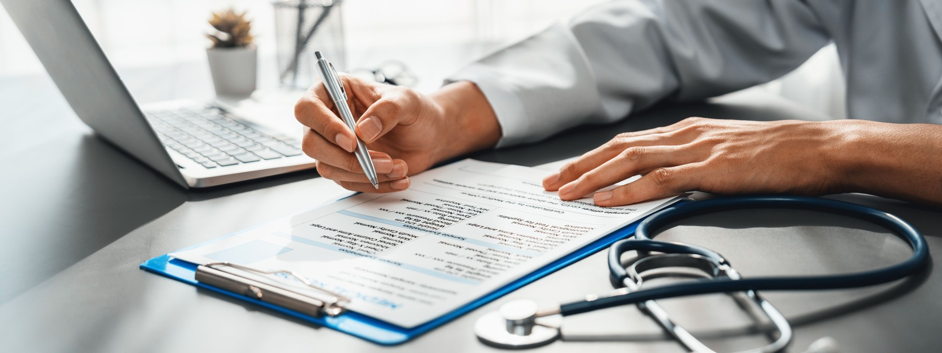 Doctor carefully review detailed medical report with laptop. Neoteric